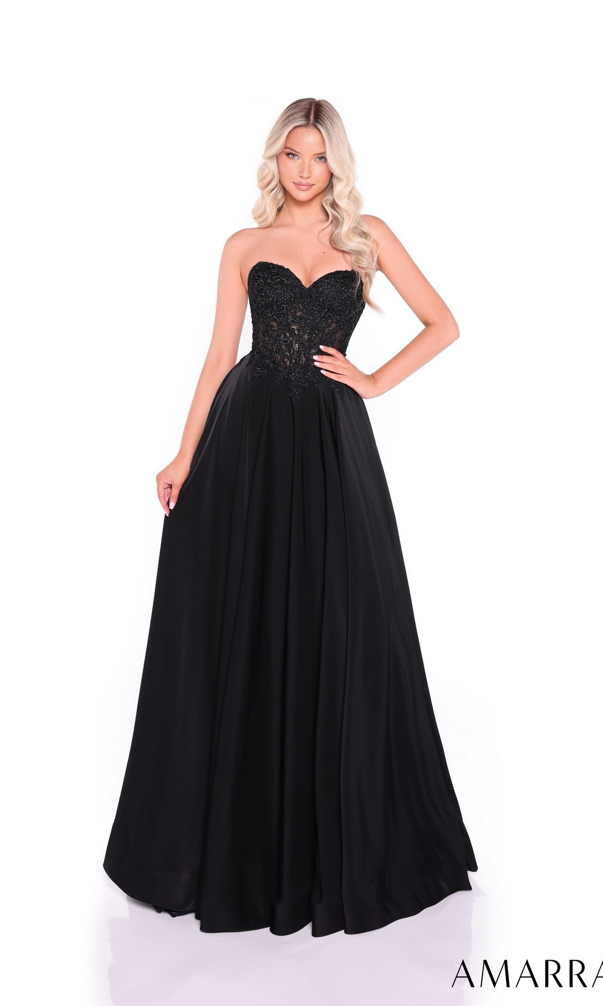 A woman stands against a white background wearing the Amarra 89433 long prom dress, featuring a strapless design with a fitted lace corset bodice and a flowing skirt.